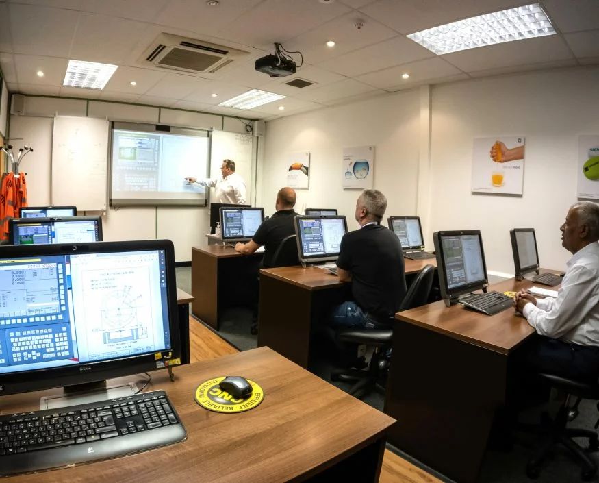 Trainees learning CNC skills
